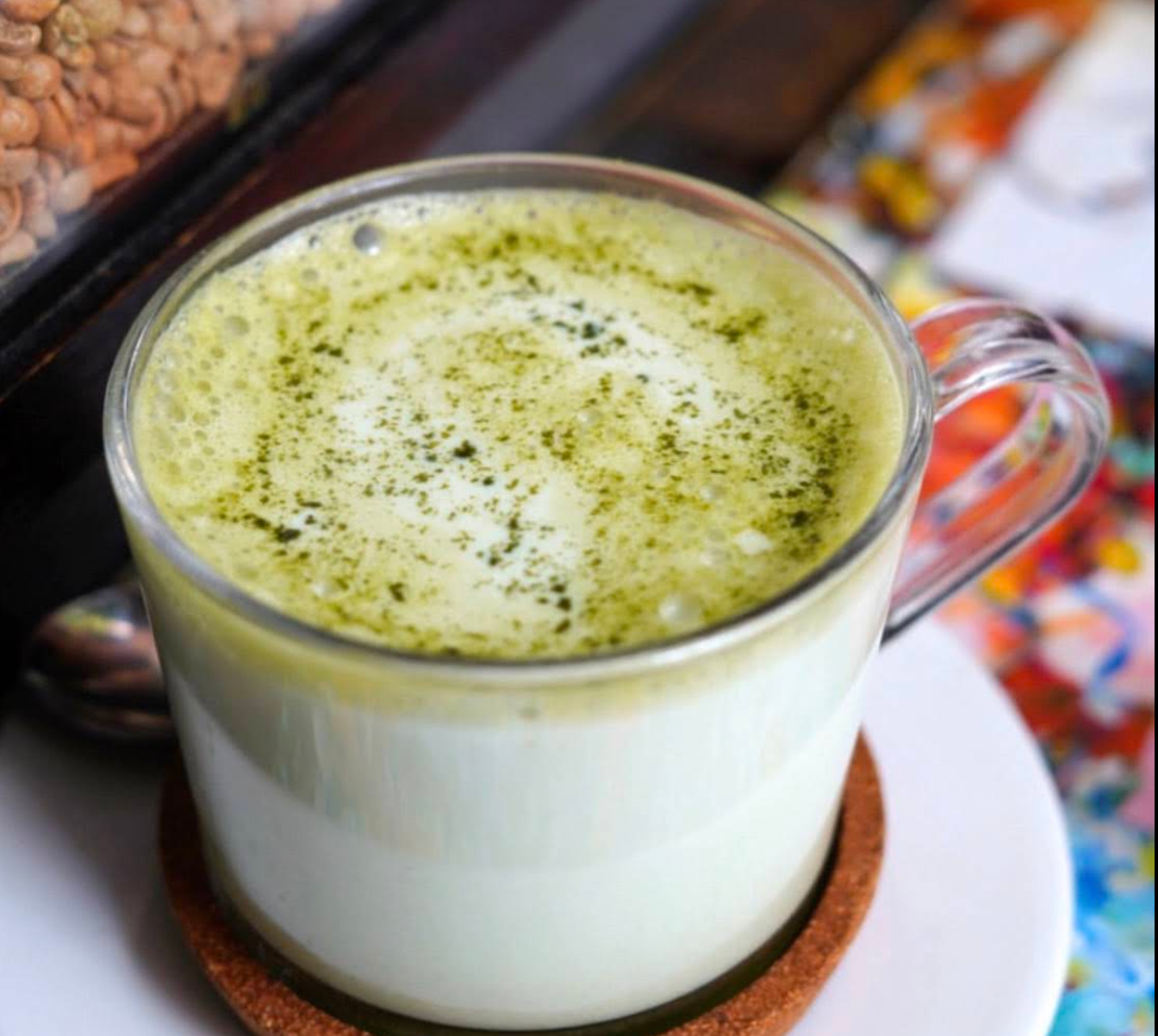 A matcha cappuccino dusted with green tea powder